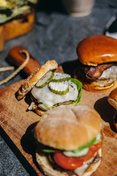 Close-up of a finished grass-fed burger with toppings